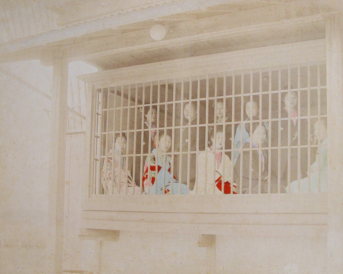 YOSHIWARA. - Prostitutes in Yoshiwara district Tokyo behind cage.