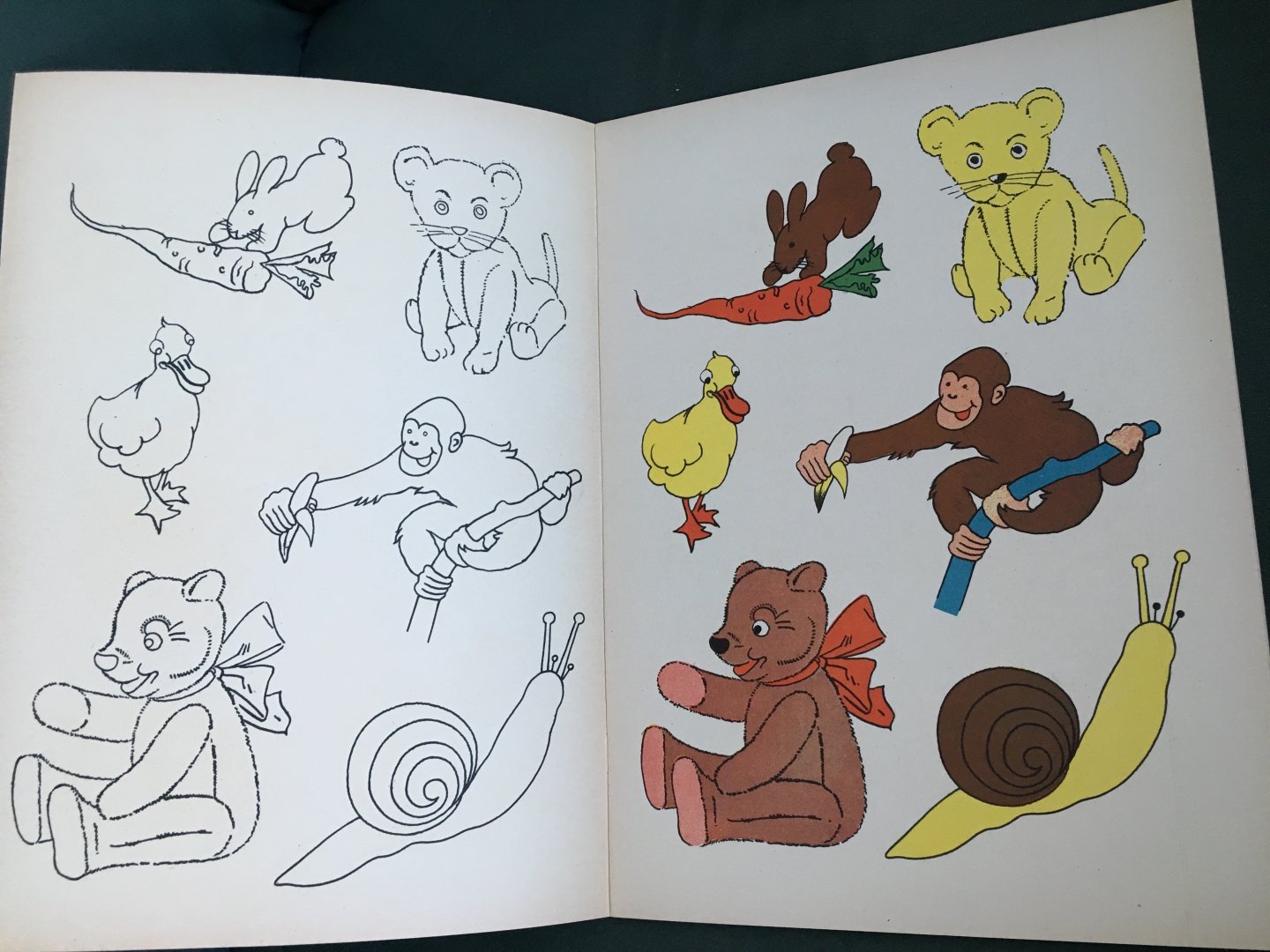  - Animal  Drawings. Blue colouring book where a girl is colouring a chicken and a boy an elephant
