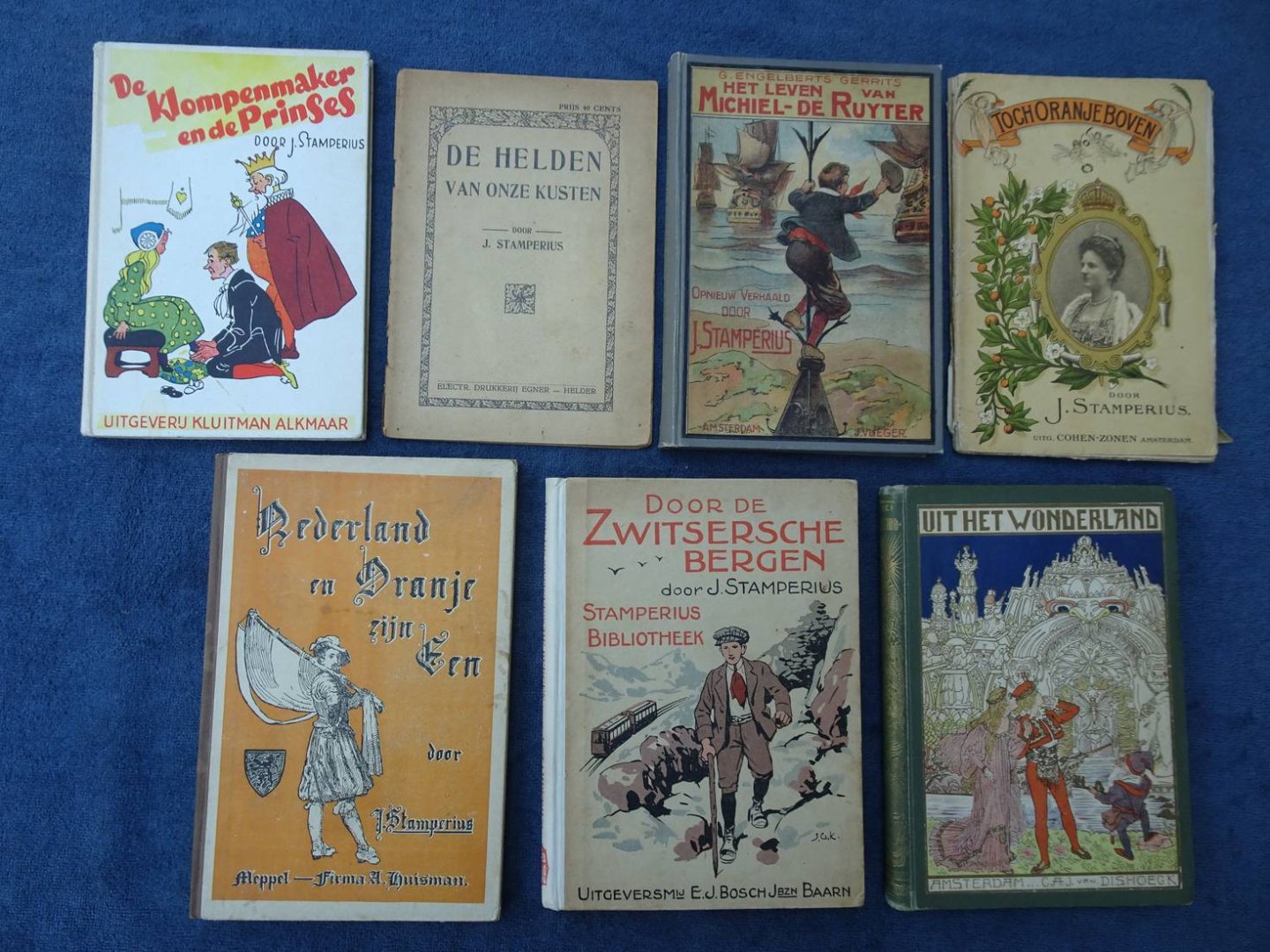 Stamperius, J.. - De helden van onze kusten/ De klompenmaker en de prinses/ Het leven van Michiel de Ruyter/ Toch Oranje boven/ Nederland en Oranje zijn één/ Door de Zwitsersche bergen/ Uit het Wonderland. 7 stuks.