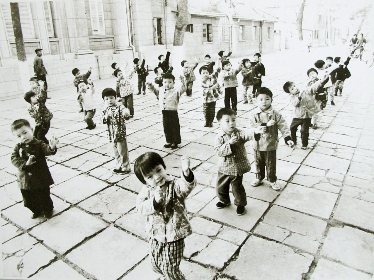 HANSEN, Ben - China. Group of toddlers practising tai-ch in the street.