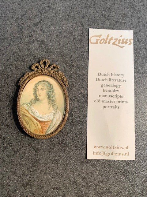  - Attractive miniature portrait of a woman with curly hair and in beatiful classical dress painted on ivory.