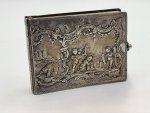 - Beautiful silver notebook adorned with rocailles and relief scenes featuring putti.