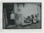 SHANGHAI. - Yueyuan Road. Oldtown Shanghai. Waitress in doorway with two chicken-children toys in front.