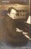 Reger, Max: - [Fotopostkarte, halbe Figur nach halbrechts, am Klavier]