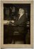  - [Photography 1920] Portrait photo of librarian dr. C.P. Burger, seated at a desk. 12x10 cm, ca. 1920.